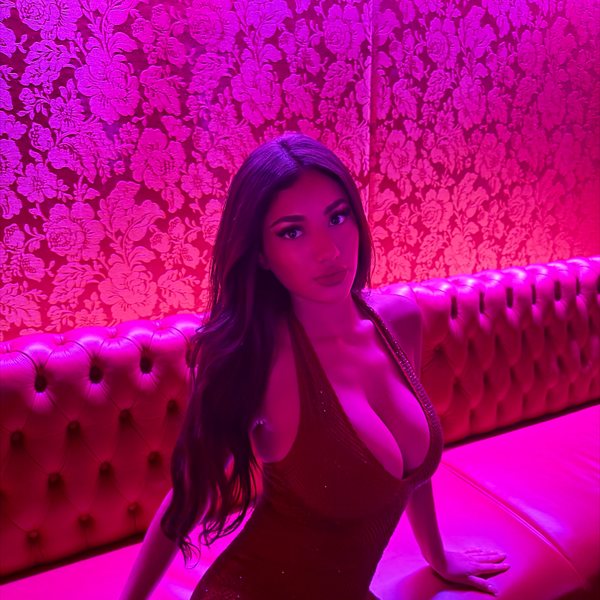 Jasmine in a pink-lit lounge
